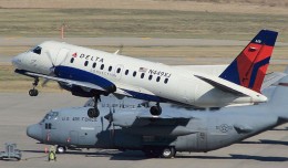 Some US Air Force C-17s watch a Delta Connection Saab 340A (N449XJ) take off from Minneapolis