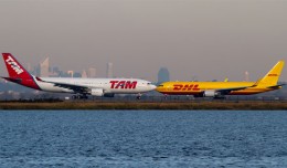 TAM Airbus A330 lined up to depart JFK as a DHL Boeing 767 taxis to the runway