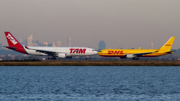 TAM Airbus A330 lined up to depart JFK as a DHL Boeing 767 taxis to the runway