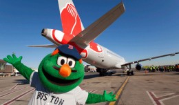 Wally the Green Monster poses with JetBlue's new Red Sox ship, Airbus A320 tail number 605 (N605JB). (Photo by JetBlue)