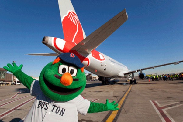 Wally the Green Monster poses with JetBlue's new Red Sox ship, Airbus A320 tail number 605 (N605JB). (Photo by JetBlue)