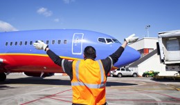 A Southwest ramper directs one of the first of the airline's planes to land in Atlanta