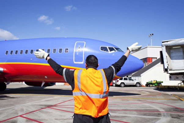 A Southwest ramper directs one of the first of the airline's planes to land in Atlanta
