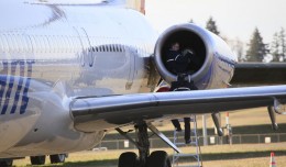 A technician examines the left engine of an Allegiant Air MD-83 at Paine Field, Wash., after it made an emergency landing.