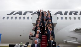 Officials from Japan Airlines, Boeing and GE pose for a photo with the carrier's newly delivered 787 Dreamliner.