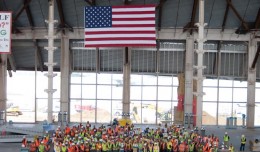 LAWA staff, construction workers from Walsh-Austin Joint Venture, and special guest, veteran Pete Howenstein pose in the great hall of the South Concourse with an American flag during a pre-Memorial Day tribute, May 24, 2012. (Photo by Stephen Shrank/NYCAviation)