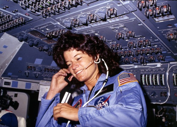 Sally Ride communicates with ground controllers from the flight deck of Space Shuttle Challenger during her first mission in space, STS-7. (Photo by NASA)