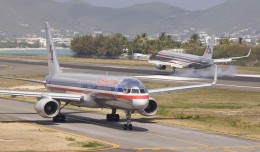 One American 757 lands at St. Maarten while another taxis for departure. (Photo by Mario J. Craig)