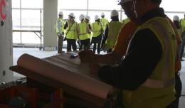 Construction workers examine blueprints inside the new Sky Club.