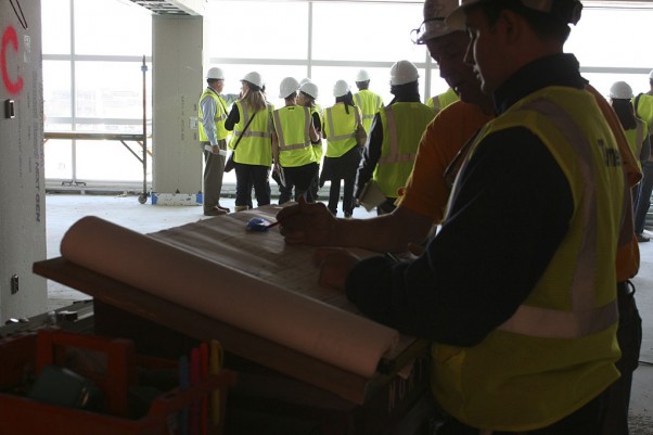 Construction workers examine blueprints inside the new Sky Club.