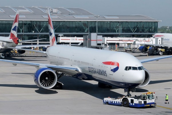 A British Airways Boeing 777-300ER (G-STBF) pushes back from a gate at Heathrow. (Photo by Ken Iwelumo via wikimedia)