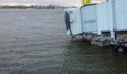 Water laps at a jetway outside LaGuardia's Central Terminal. (Photo via Fox5)