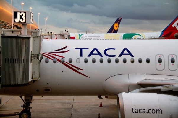 TACA Airbus parked at a gate. (Photo by Frederick Durand via wikimedia, CC-BY-SA)