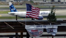 The final I-beam used in constructing the new T5i on display, with a JetBlue A320 in the background