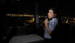 MIA employee Khristine Perez works a ground tower in the dark after a power outage
