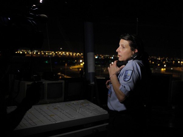 MIA employee Khristine Perez works a ground tower in the dark after a power outage